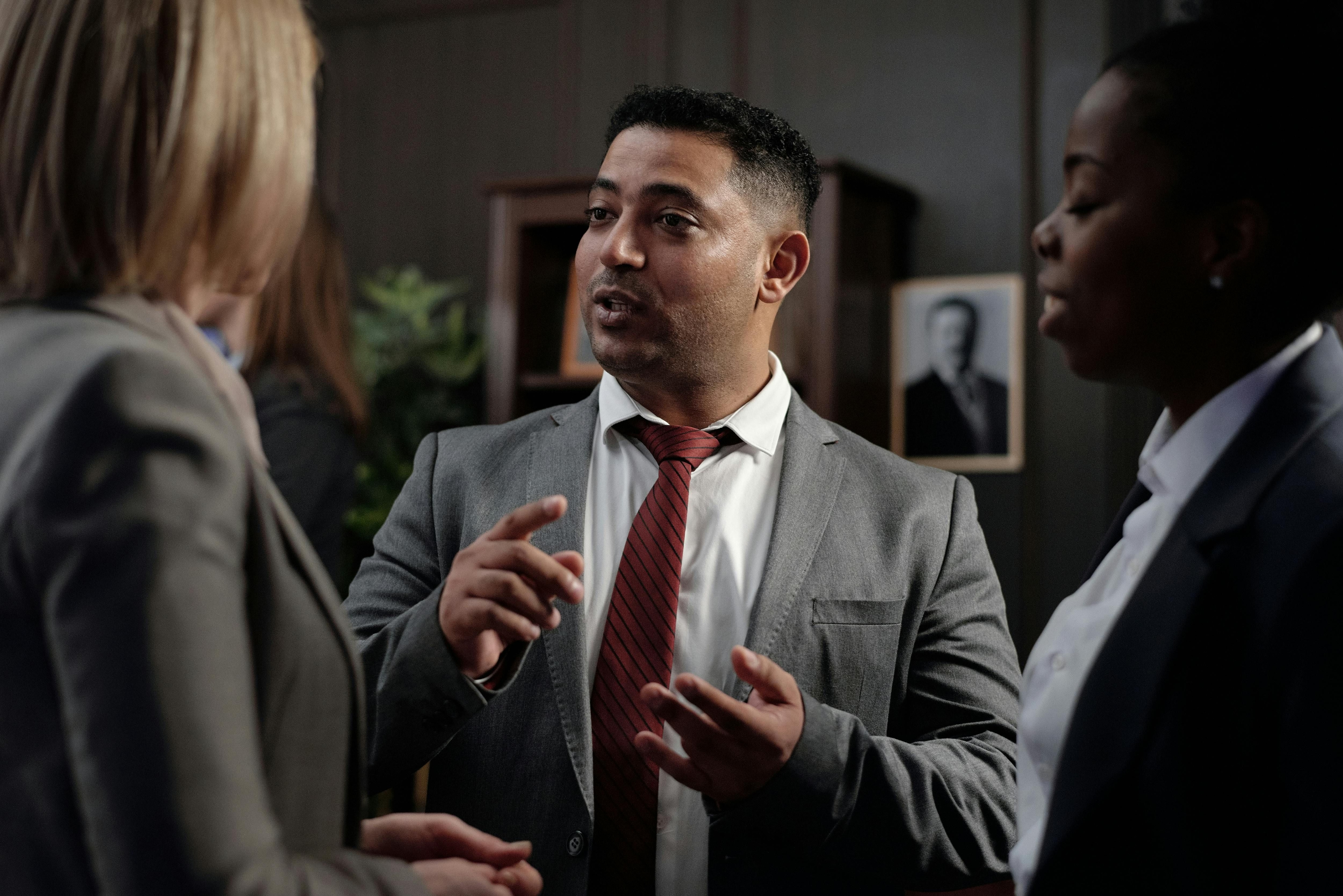 um homem e duas mulheres conversando em um evento de networking